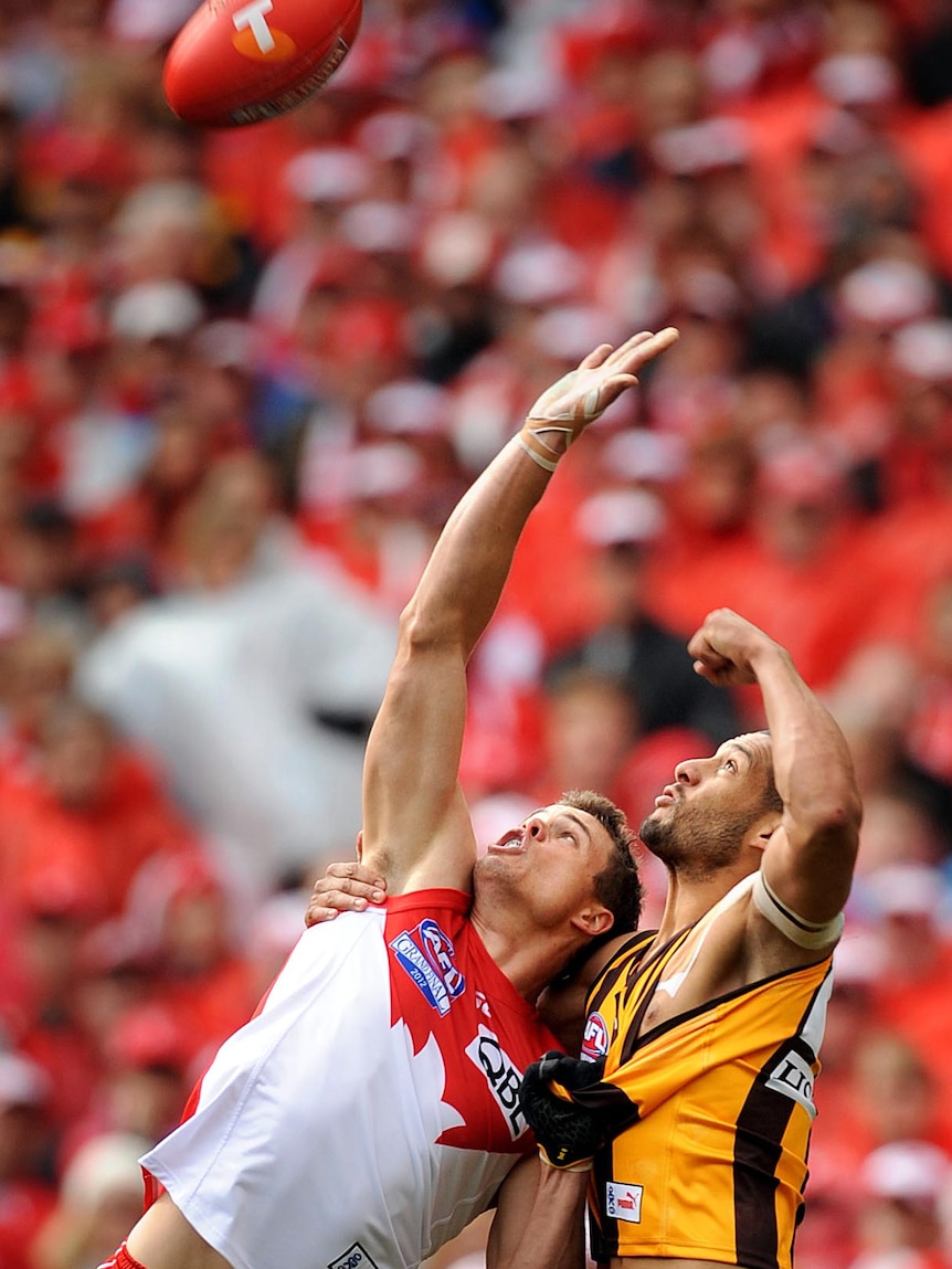 Josh Gibson of Hawthorn has his jersey pulled by Mike Pyke of Sydney during the 2012 grand final.