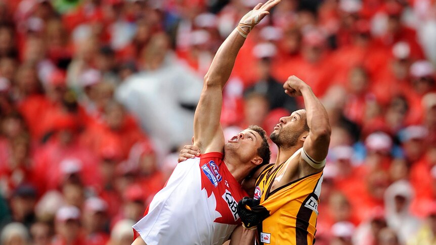 Josh Gibson of Hawthorn has his jersey pulled by Mike Pyke of Sydney during the 2012 grand final.