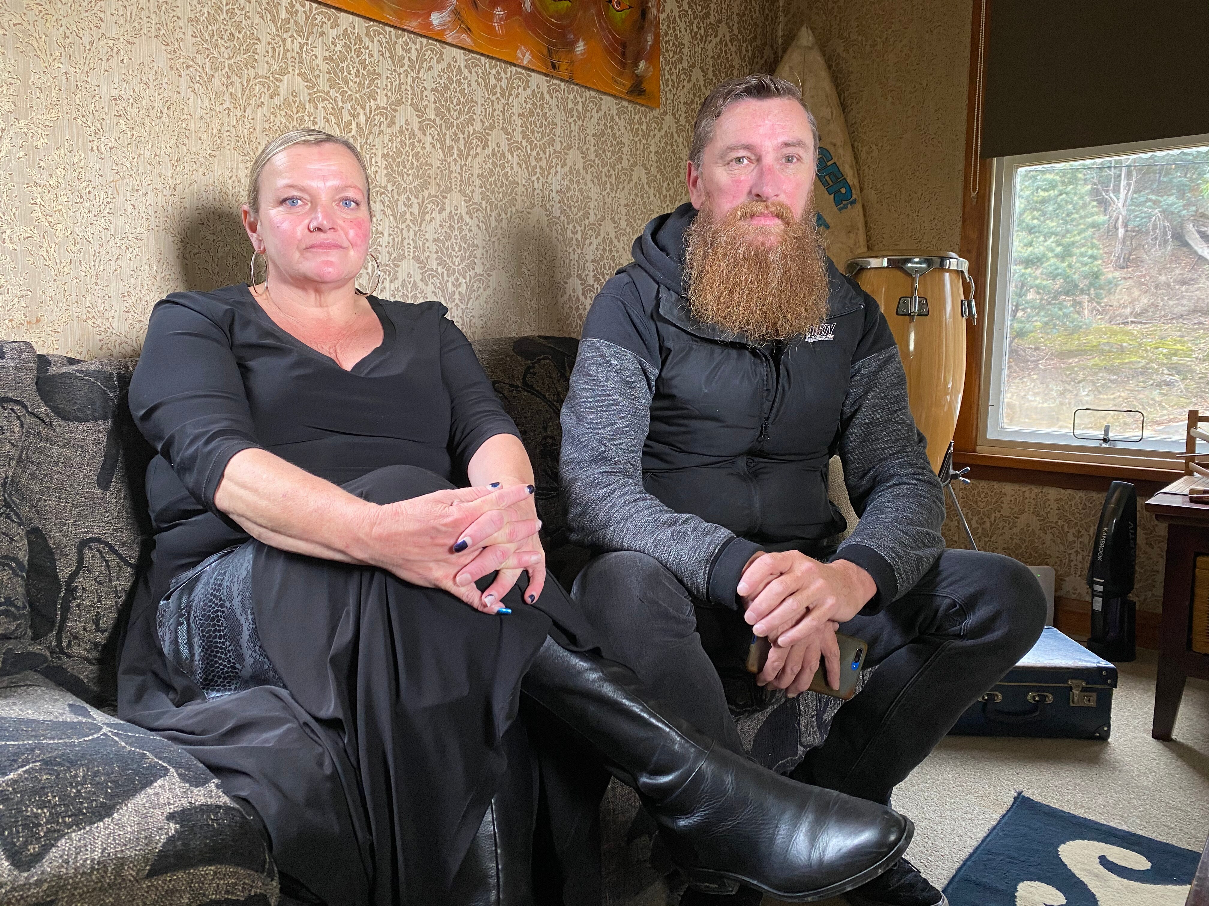 A man and a woman sitting on the couch.