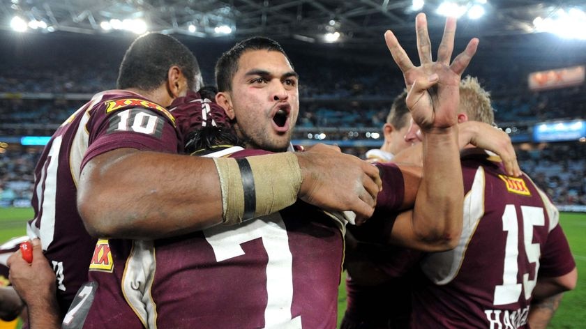 Qld's Karmichael Hunt holds up four fingers after the Maroons won their fourth successive series win