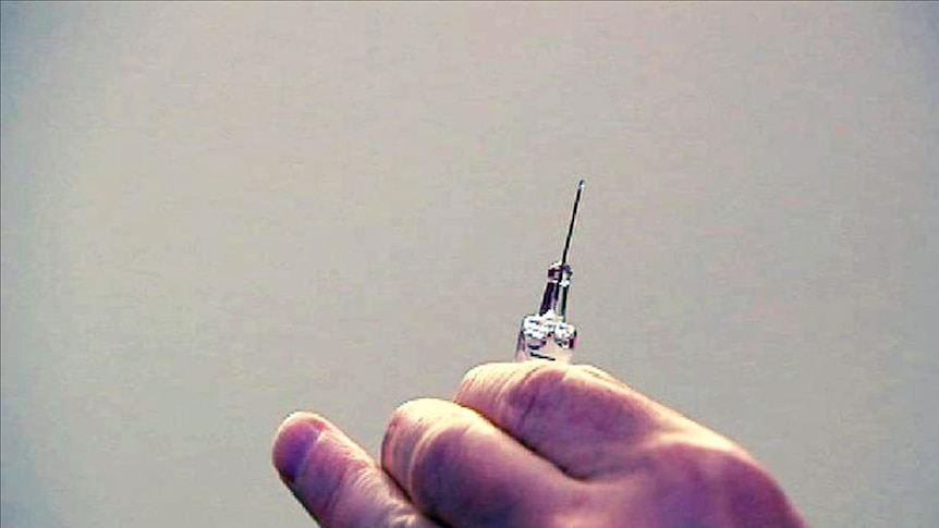 hand holding syringe