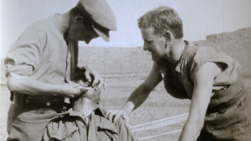Two men extract tooth from patient at Gallipoli World War 1