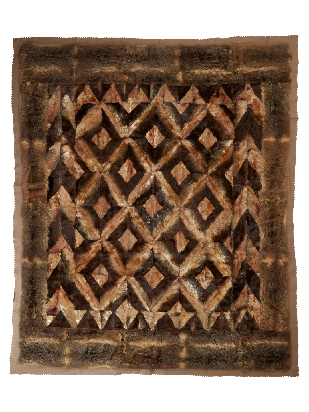 A platypus skin rug made into a diamond pattern with brown possum skin and fawn felt border.