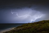 Dark clouds and lighting over a beach in Perth