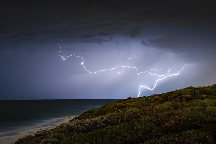 Dark clouds and lighting over a beach in Perth