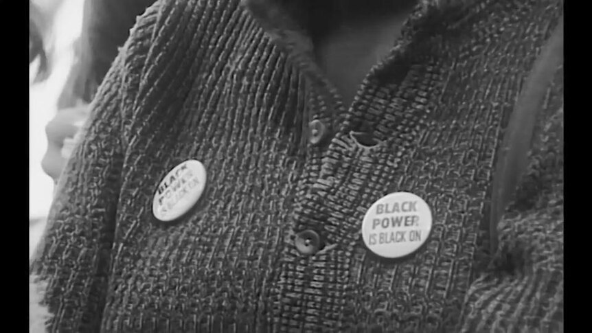 Black and white photo of badges on jumper, text reads "Black Power is Black On"