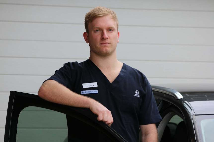 Nurse Tristan Streefland next to his car