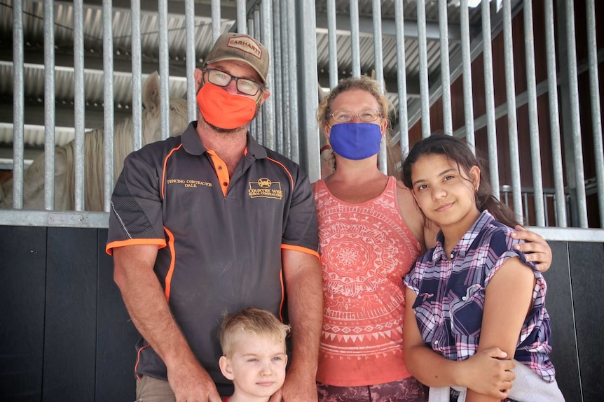 Dale Perovic and partner Naomi Konkoly-Fripp pictured with their children wearing masks.
