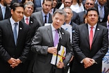 Colombian President Juan Manuel Santos holds a copy with the final text of the peace agreement.