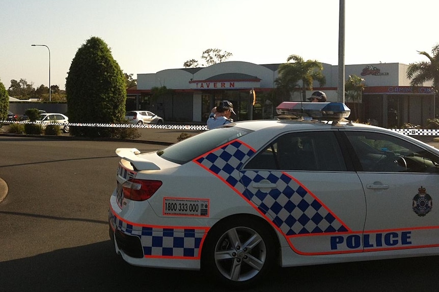 Police stand outside the Arundel Tavern on the Gold Coast.