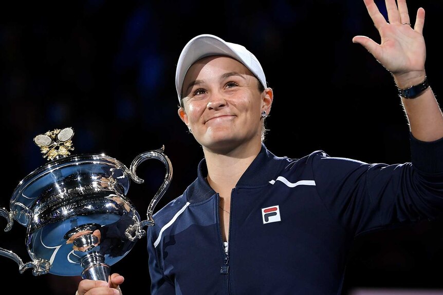 Ash Barty of Australia waves as she holds the Daphne Akhurst Memorial Cup in Melbourne.