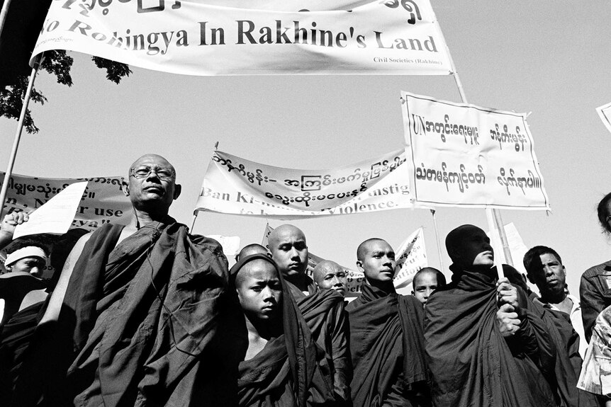 Rakhine Buddhist protestors hold signs during an anti-Rohingya demonstration.