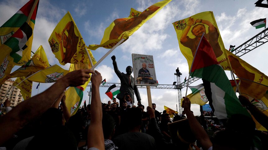 The Nelson Mandela statue is seen as demonstrators take part in a rally in support of Palestinian prisoners.
