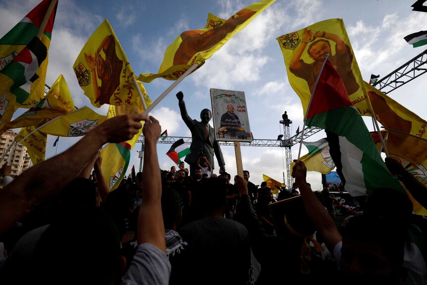 The Nelson Mandela statue is seen as demonstrators take part in a rally in support of Palestinian prisoners.