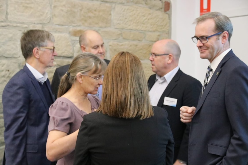 Health Minister Michael Ferguson speaks with experts.