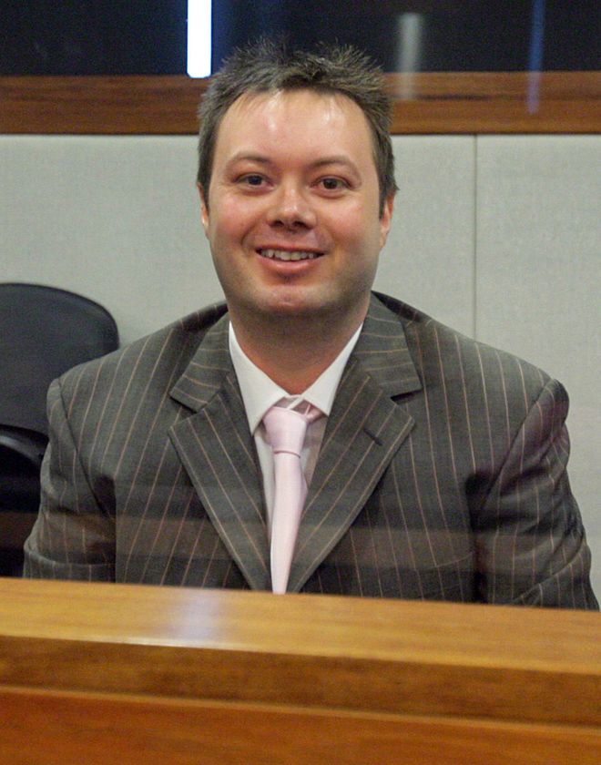 Carl Williams, un hombre de pelo corto y cara redonda, sonríe.