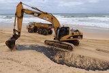 Digger cleans up Queensland oil slick