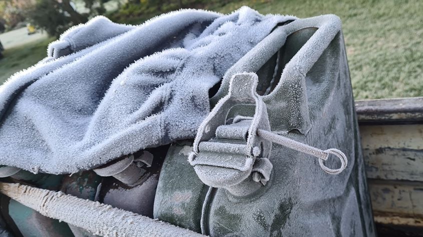 Frost covering a jumper and jerry cans