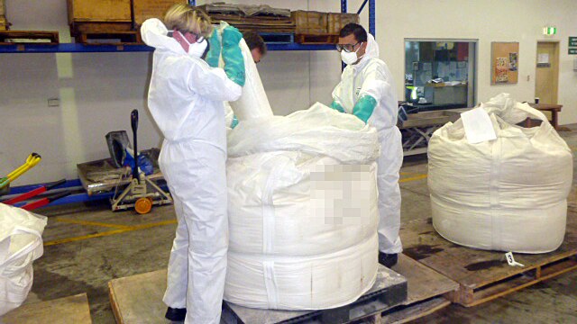 Police officers examine a seized bag of the drug Ice.