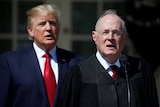 US President Donald Trump listens as Justice Anthony Kennedy speaks.