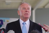 A head and shoulders shot of Colin Barnett talking to reporters.