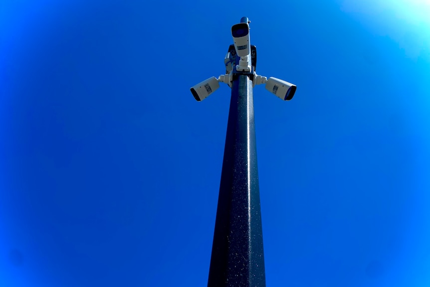 Surveillance cameras mounted on a pole. 