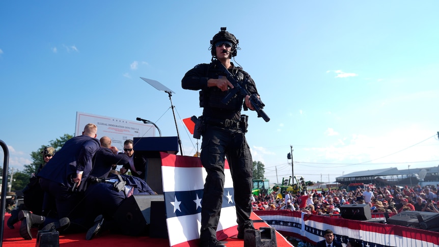Secret service army stands with gun 
