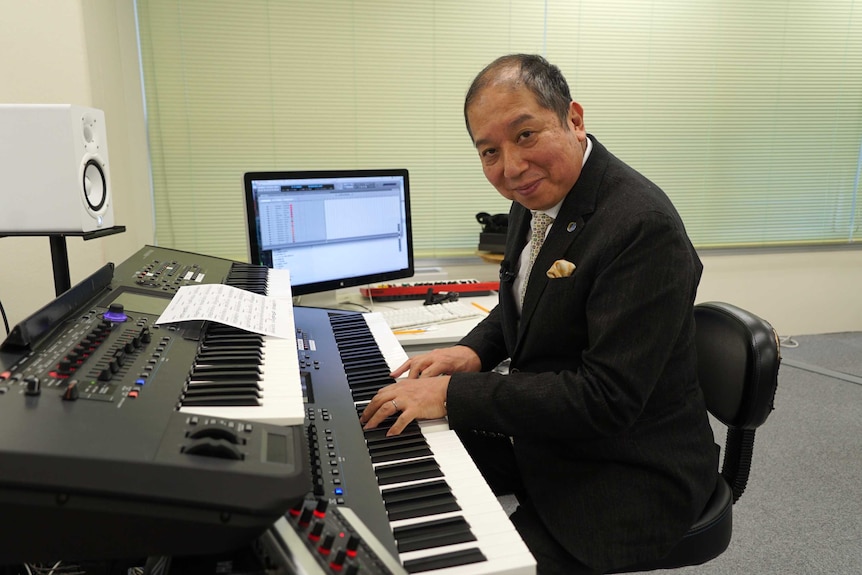 Composer Minoru Mukaiya at his keyboard.