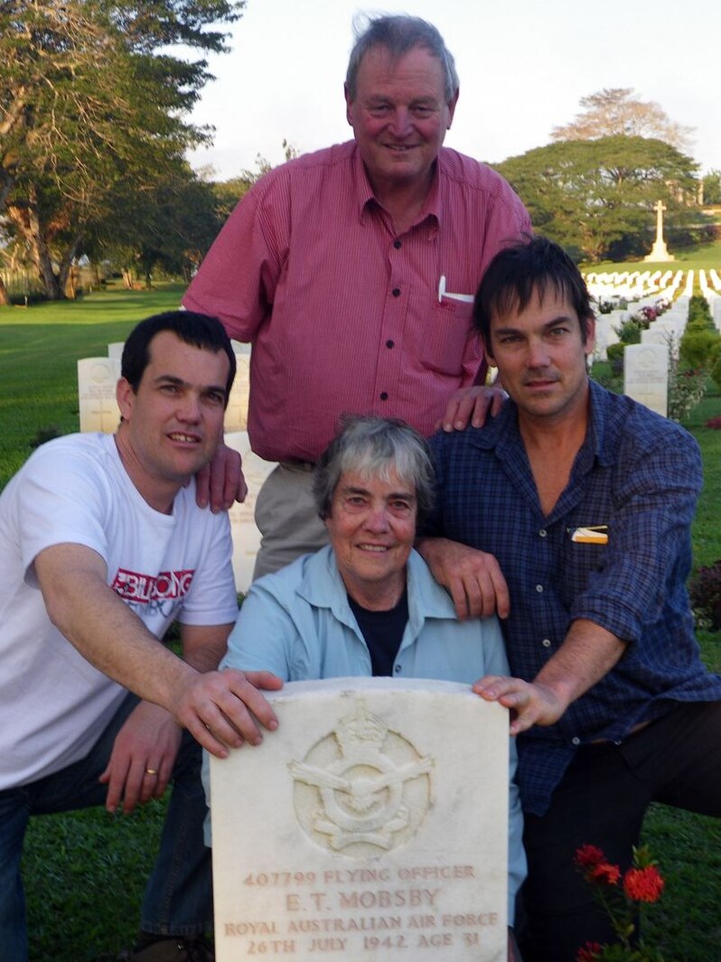 Edward Mobsby's family at his grave in Papua New Guinea.