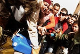 An injured member of Gaddafi's forces is paraded through Benghazi after his capture.