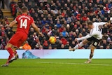 Manchester United's Wayne Rooney volleys a goal against Liverpool at Anfield in the Premier League.