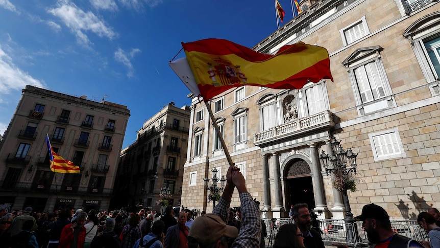 Spanish and Catalan separatist flags are waved in Barcelona.