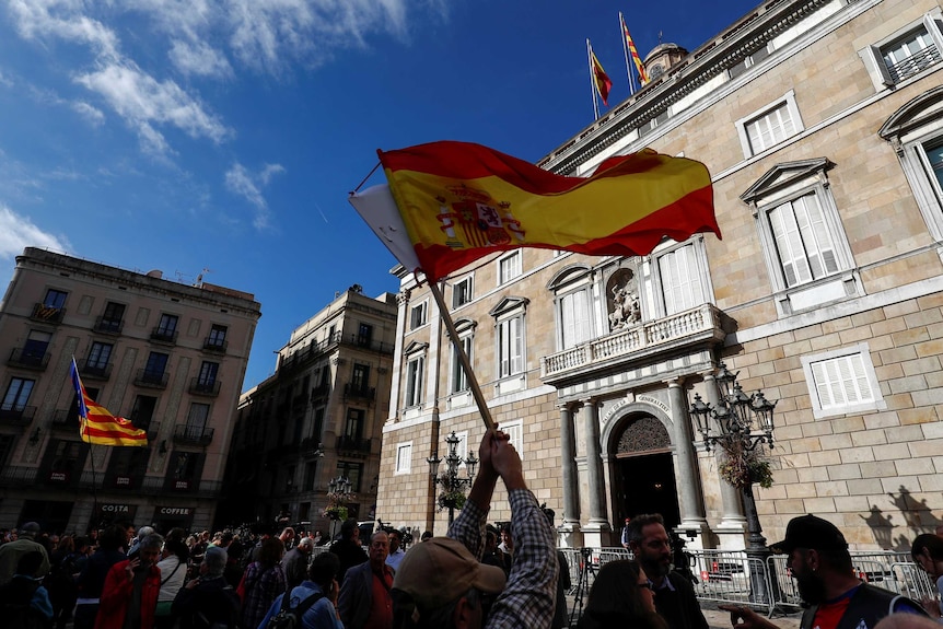 Spanish and Catalan separatist flags are waved in Barcelona.