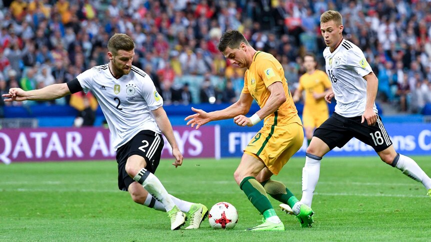 Australia's Tomi Juric takes on Germany's Shkodran Mustafi at Confederations Cup on June 19, 2017.