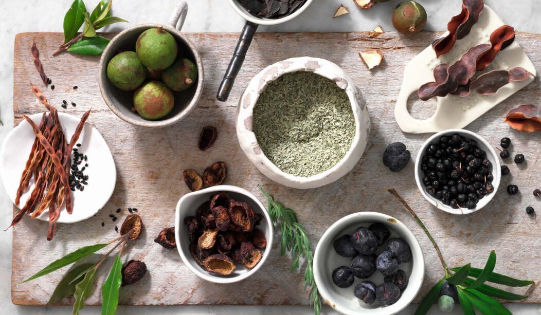 Native ingredients laid out on a chopping board;  salt bush, wattle seed and lemon myrtle.