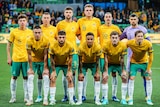The Socceroos starting XI poses for a photo before a match