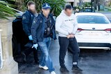 AFP officers arrest a man wearing a hoodie