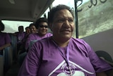 Close up image of Christina Memti in a purple shirt in a bus with four other women from the Meri Seif program