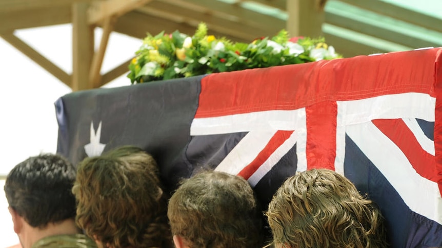 Soldiers from the Special Operations Task Group carry Sergeant Brett Wood's casket.