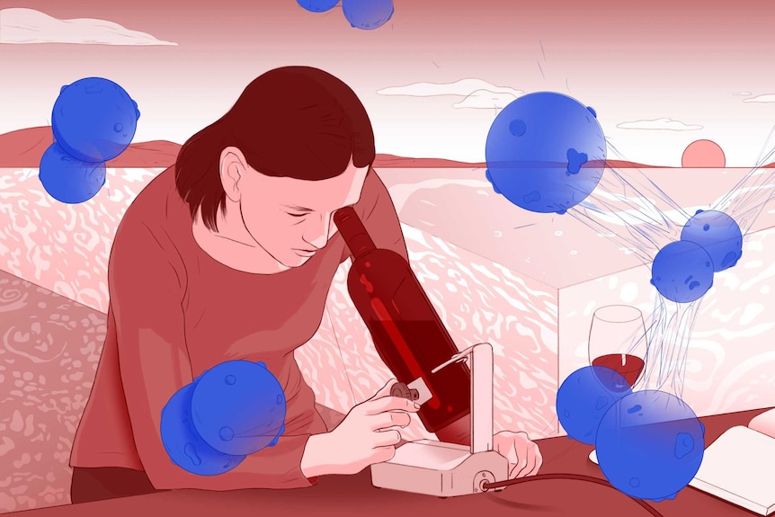 Michelle looks through a wine bottle-shaped microscope as cancer cells surround her