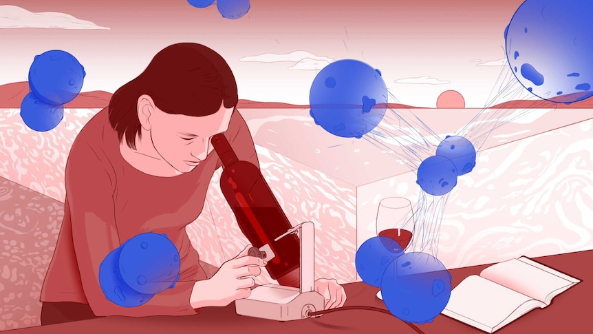 Michelle looks through a wine bottle-shaped microscope as cancer cells surround her