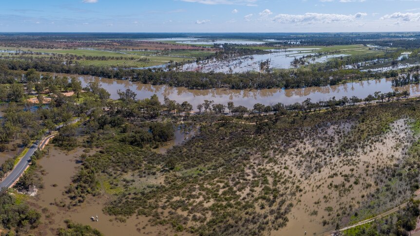 An aerial view of a river and water over a floodplain. 