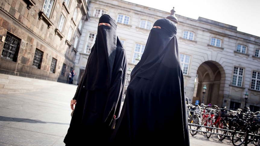 Women in niqabs at Christiansborg Palace in Copenhagen, Denmark.