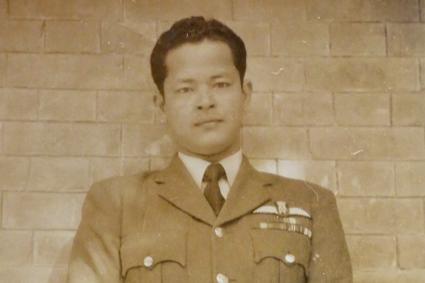 A black and white image of a military officer in his uniform.   