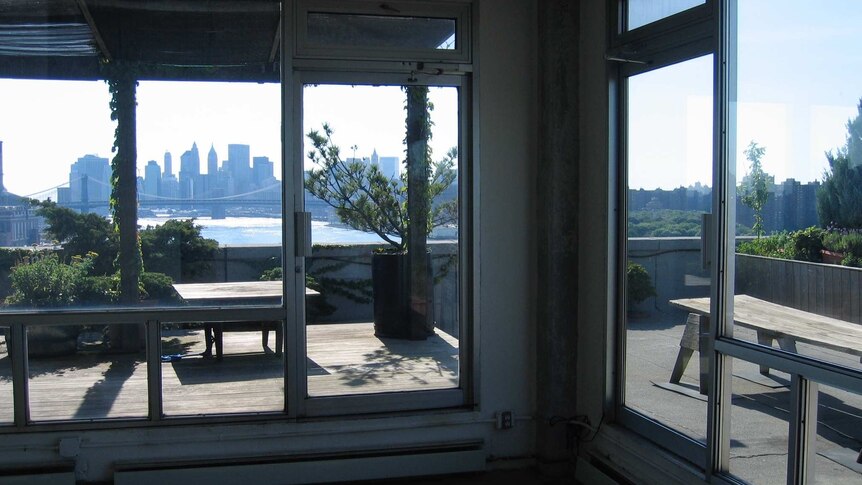 A distant view of Manhattan across the East River from an apartment.