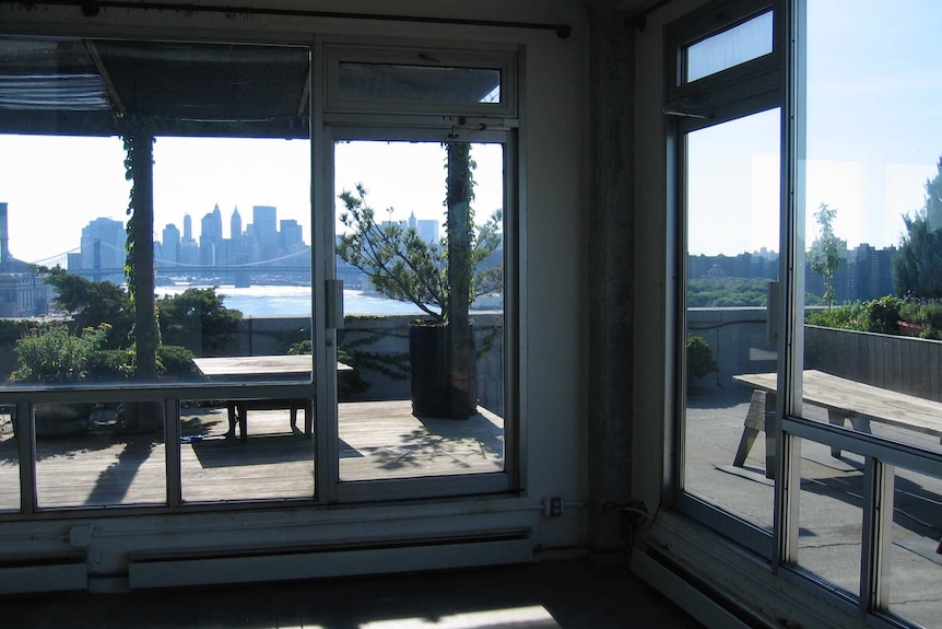 A distant view of Manhattan across the East River from an apartment.