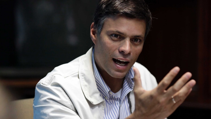 Venezuelan opposition leader Leopoldo Lopez speaks with his hand out in front of him
