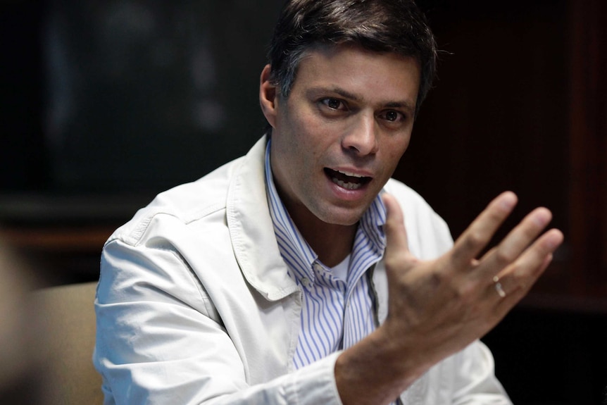 Venezuelan opposition leader Leopoldo Lopez speaks with his hand out in front of him