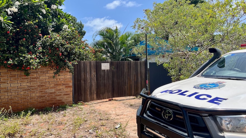 Police outside a tropical residential address