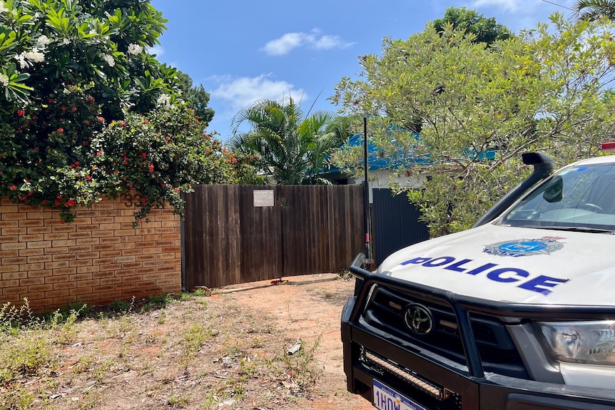 Police outside a tropical residential address